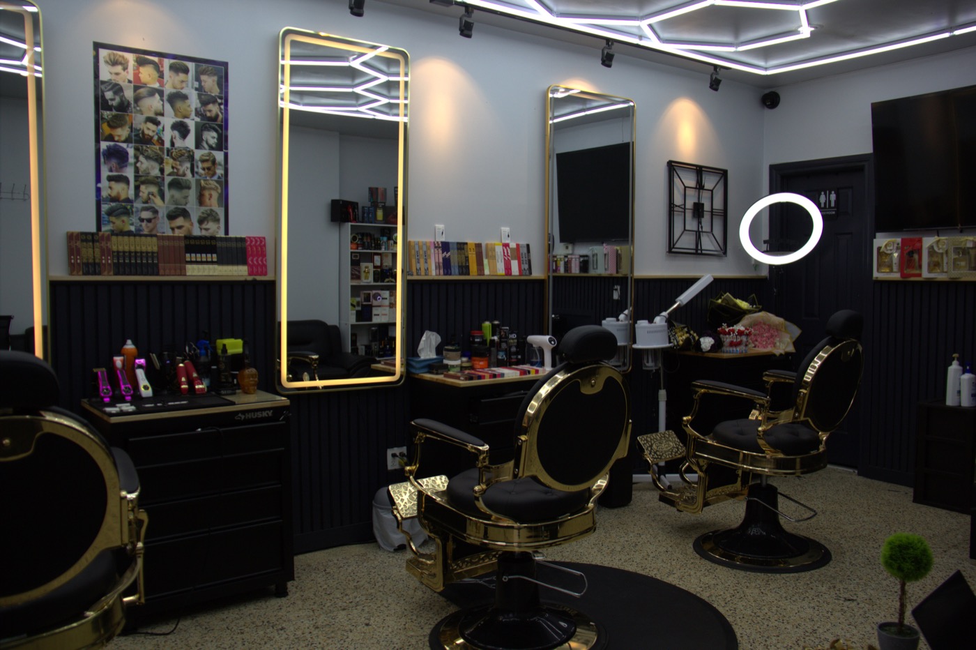 Barber styling a client inside Ibra Barbershop